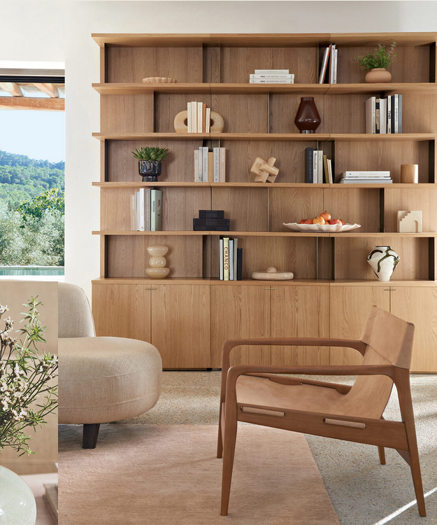 Aménagement d'un salon avec bibliothèque curée en bois naturel à Bonnieux